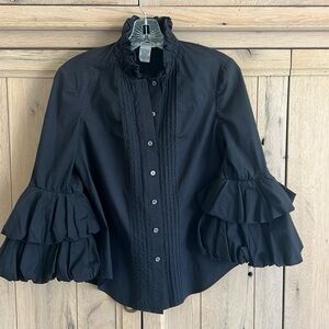 Diane Von Furstenberg black button down blouse with ruffled collar and sleeves.